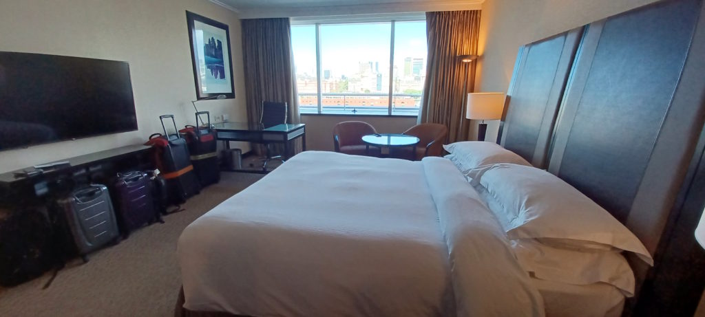 a room with a large bed and a desk
