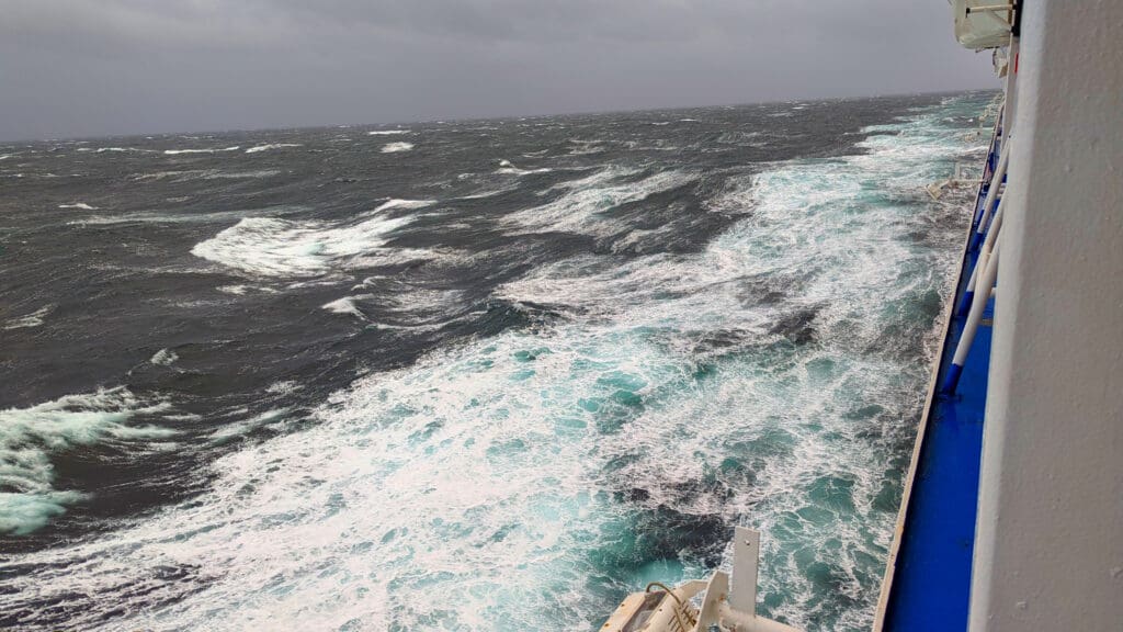 waves in the ocean with white foamy waves