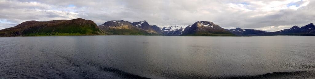 a body of water with mountains in the background