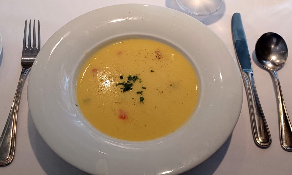 a bowl of soup with a fork and knife