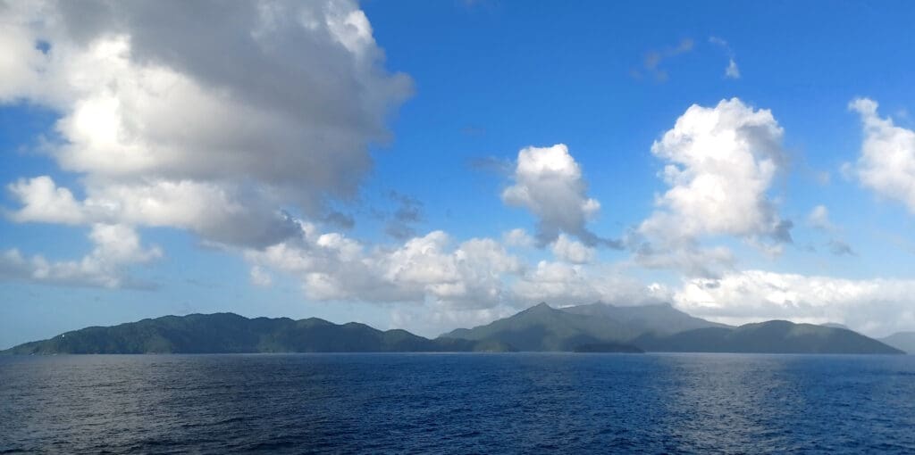 a body of water with mountains in the distance