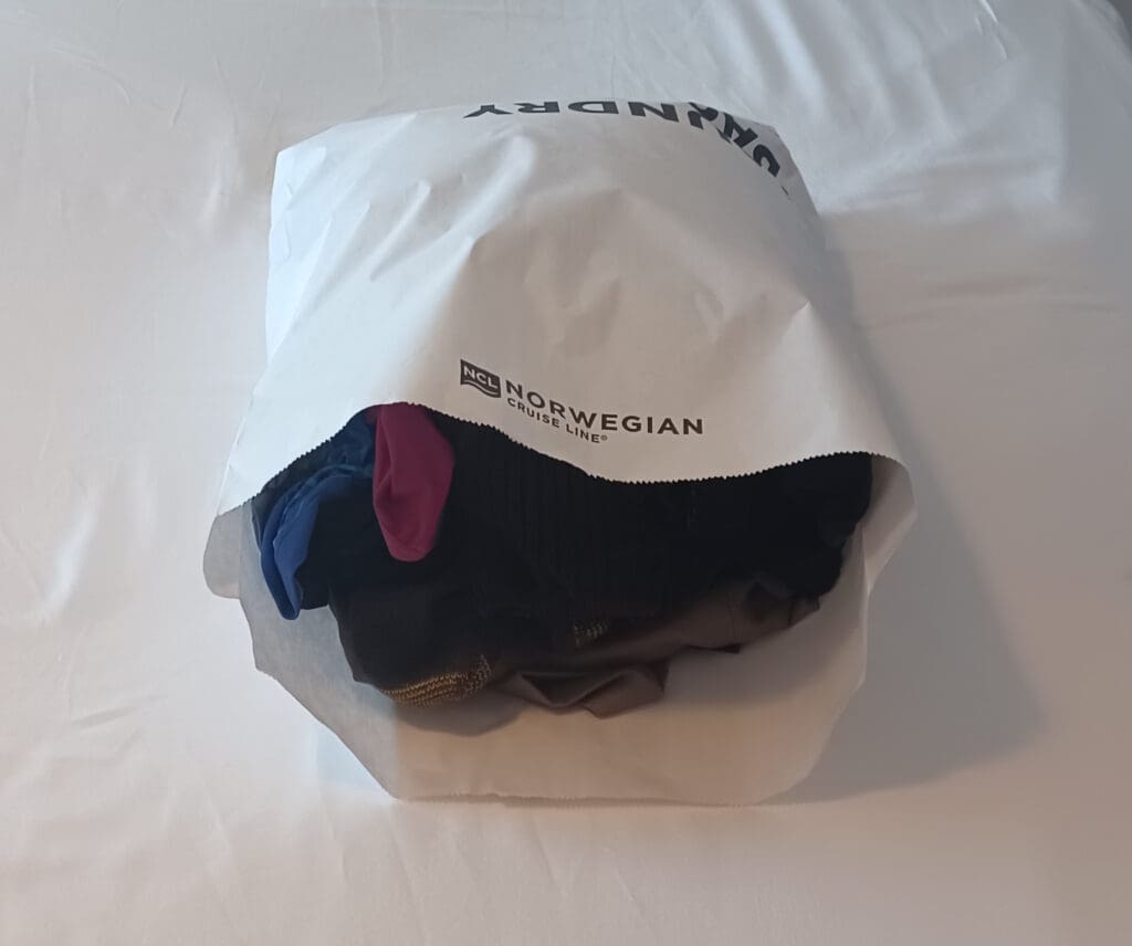 a white bag with clothes in it