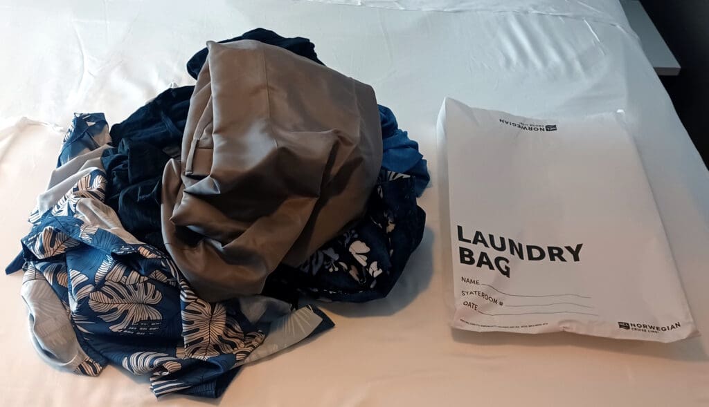 a pile of clothes on a bed