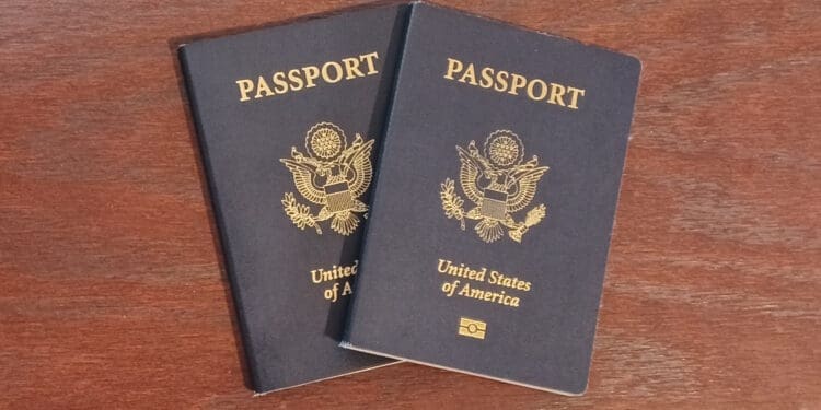 two blue passports on a wooden surface