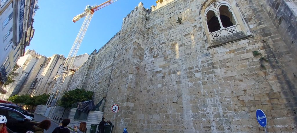 a large stone building with a crane