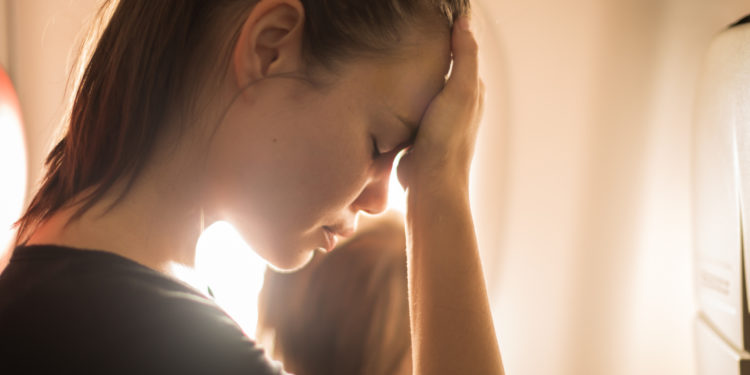Exhausted mother traveling with child