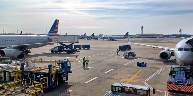 a group of people standing next to airplanes