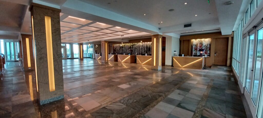 a large room with a reception desk and a tiled floor