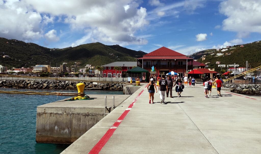 a group of people walking on a dock