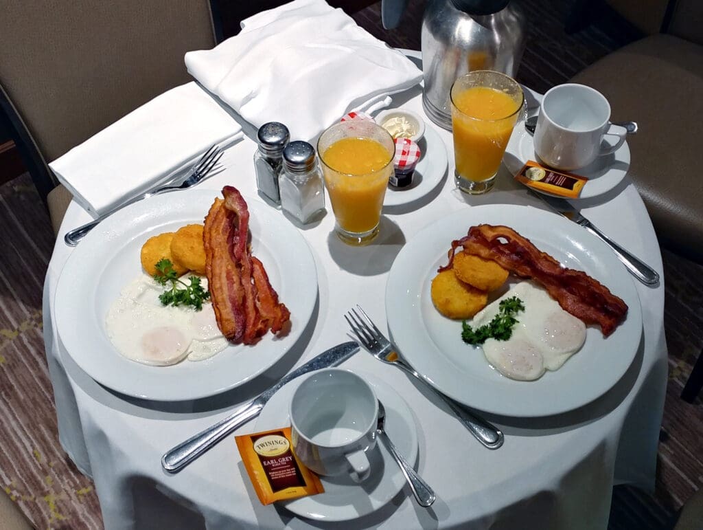 a table with plates of food and drinks