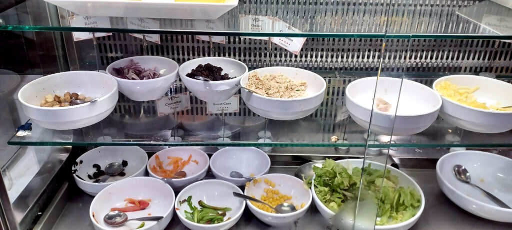 a display case with bowls of food