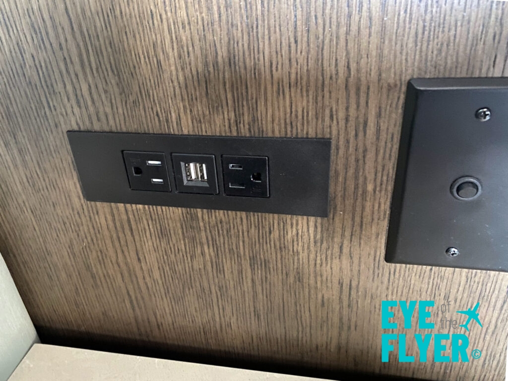 a black outlet with usb ports on a wood surface
