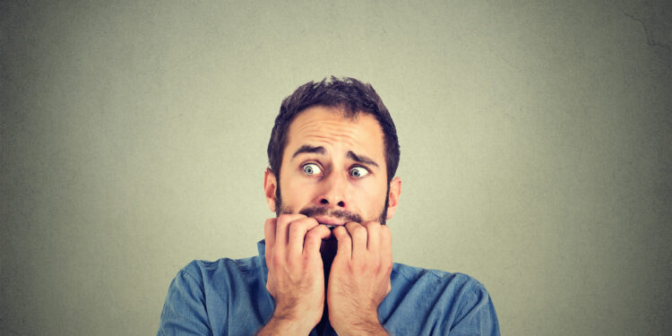 Anxious man biting his nails
