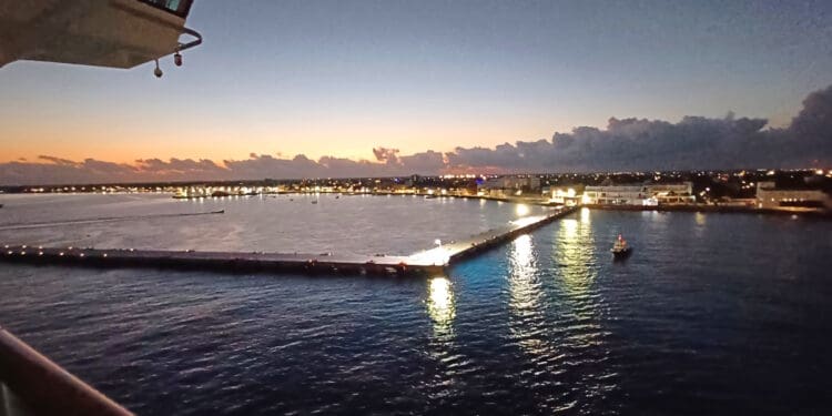 a dock with lights on it and a city in the background