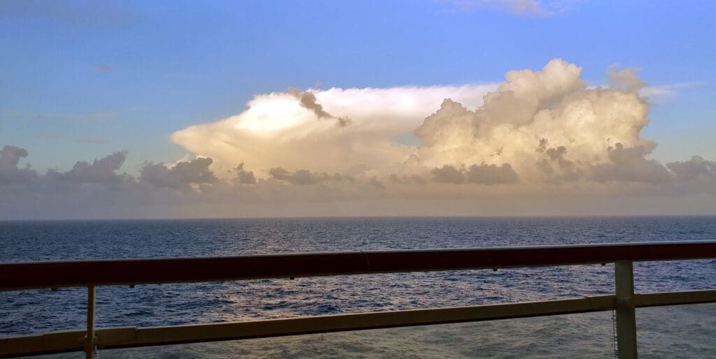 a body of water with a cloudy sky