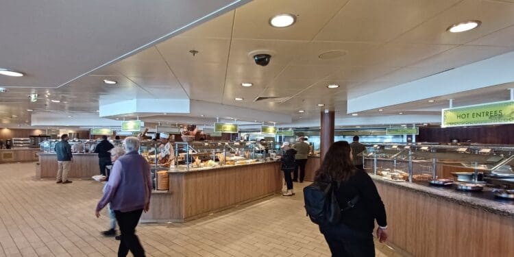 people in a restaurant with food on the counter