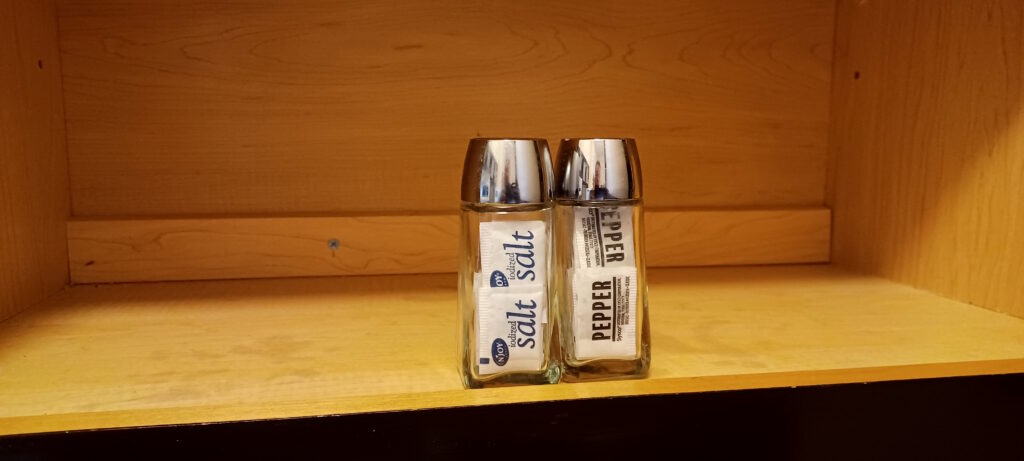 salt and pepper shakers on a shelf