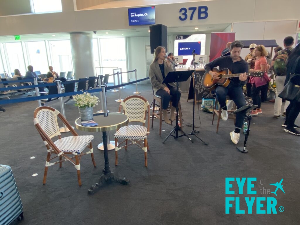 a group of people playing guitar in an airport