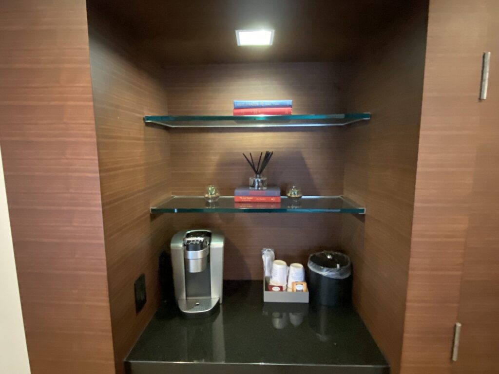 a shelf with glass shelves and objects on it