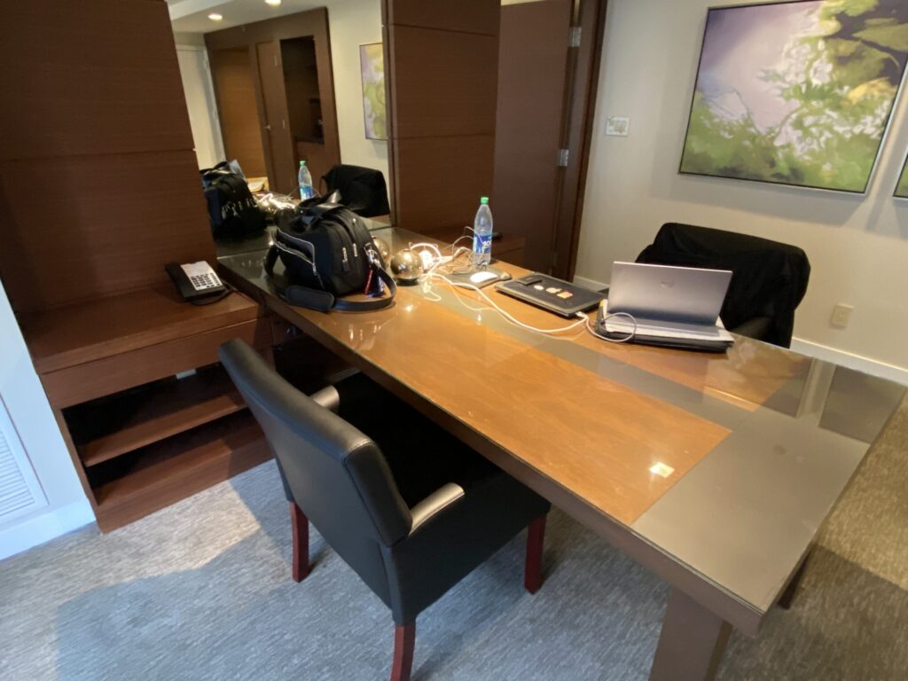 a desk with a laptop and a chair