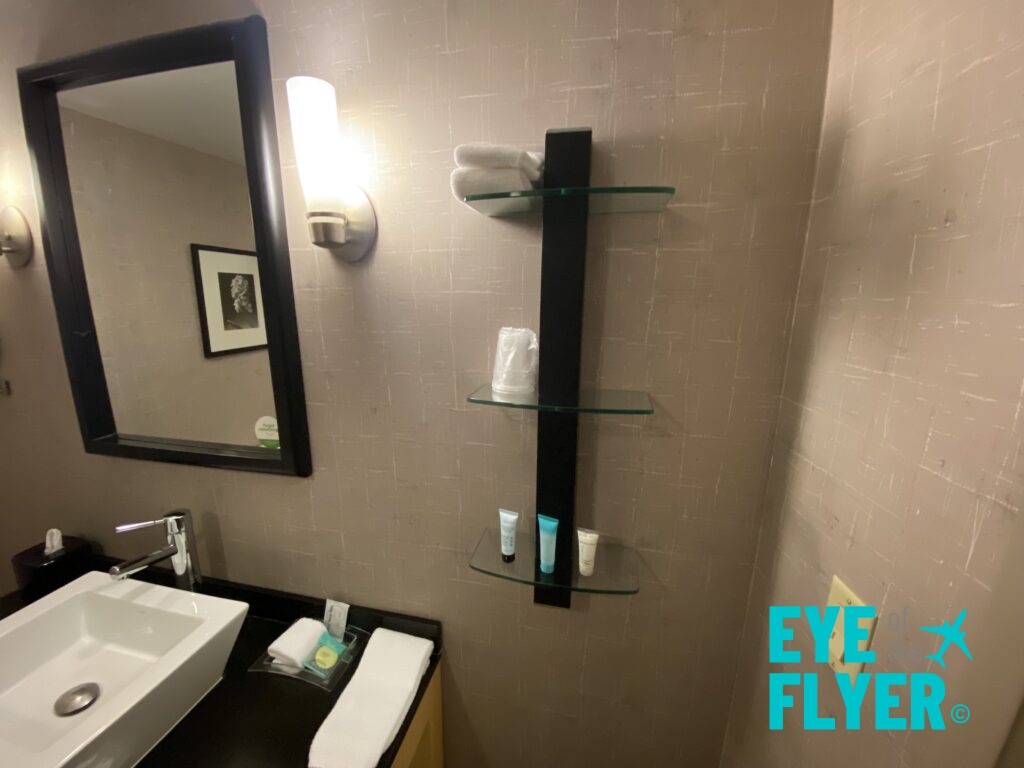 a bathroom with a mirror and shelves