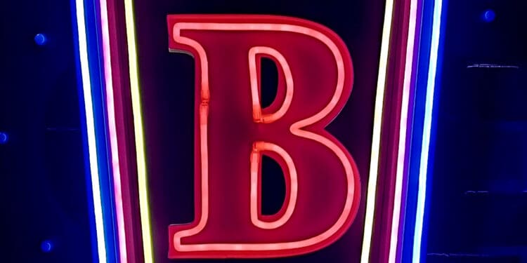 a neon sign with letters and numbers