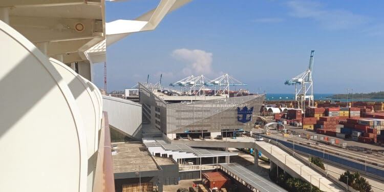 a large building with cranes in the background