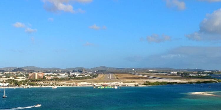 an airport runway next to a body of water