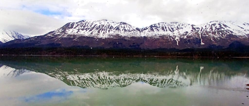 a mountain range reflected in water