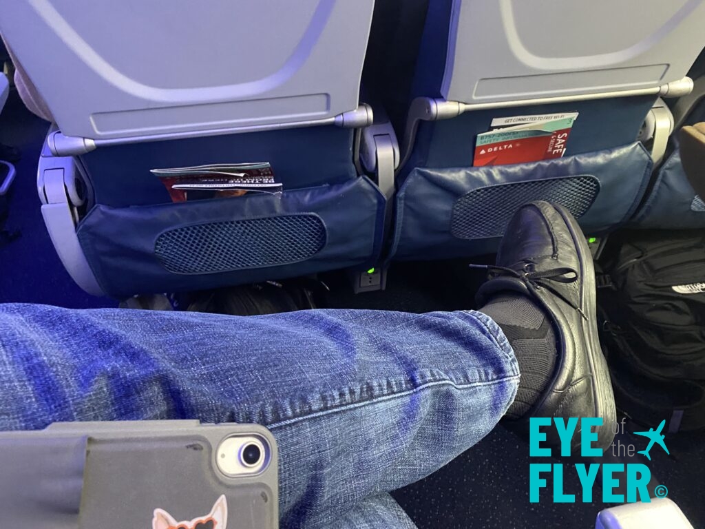 a person's leg and leg in an airplane