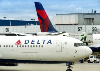 a white airplane with red and blue tail fin