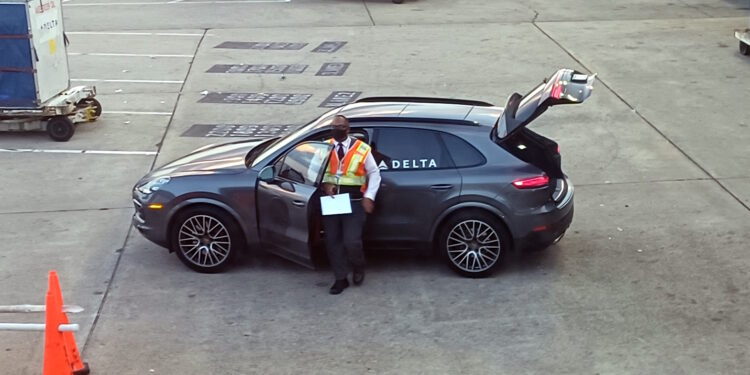 a man standing in a car with the door open