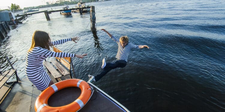 A woman throws her boyfriend off a dock