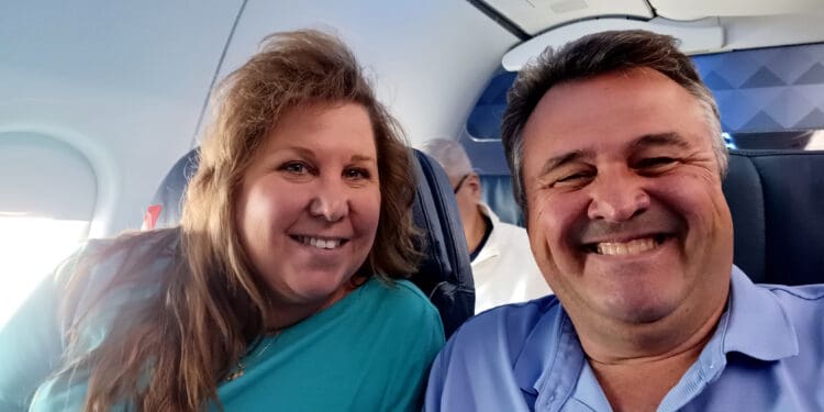 a man and woman sitting in an airplane