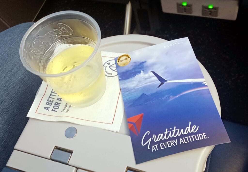 a cup of beer and a card on a table