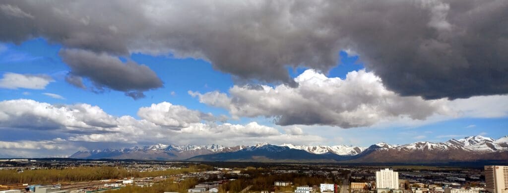 a city with snow covered mountains in the background