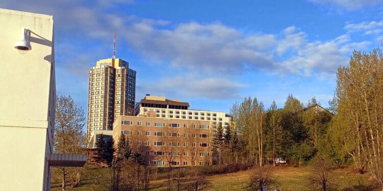 a building with trees and a blue sky