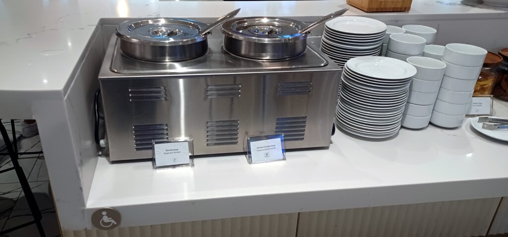 a food warmer with a couple of ladles on top