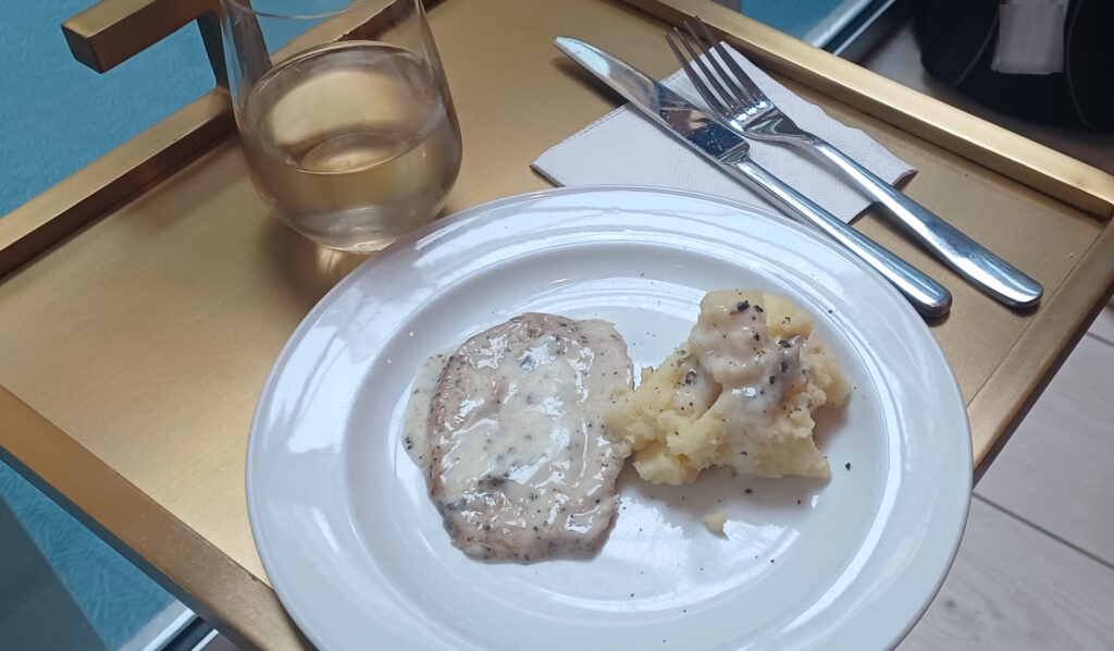 a plate of food and a glass of water