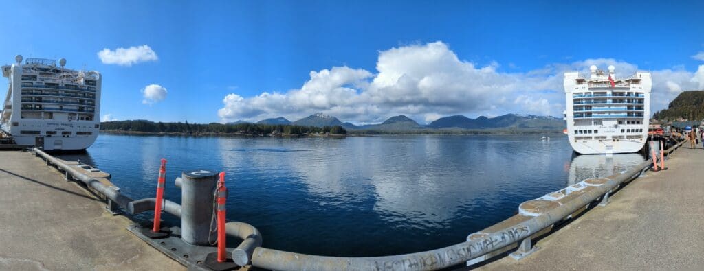 a body of water with mountains in the background