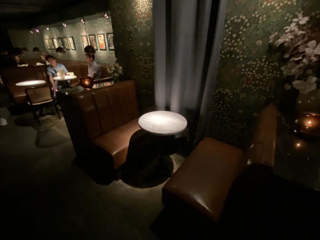 a group of people sitting at tables in a dark room