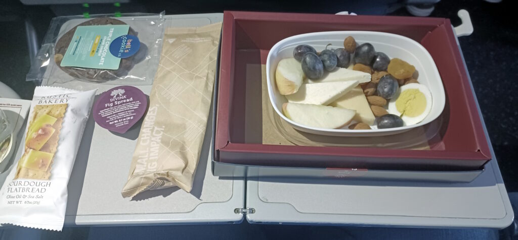a tray of fruit and nuts on a plane