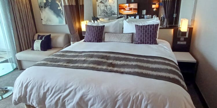 a bed with pillows in a room