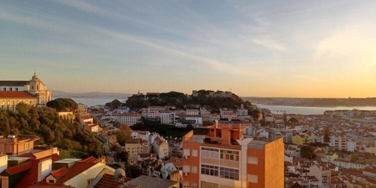 a city with a hill and water in the background