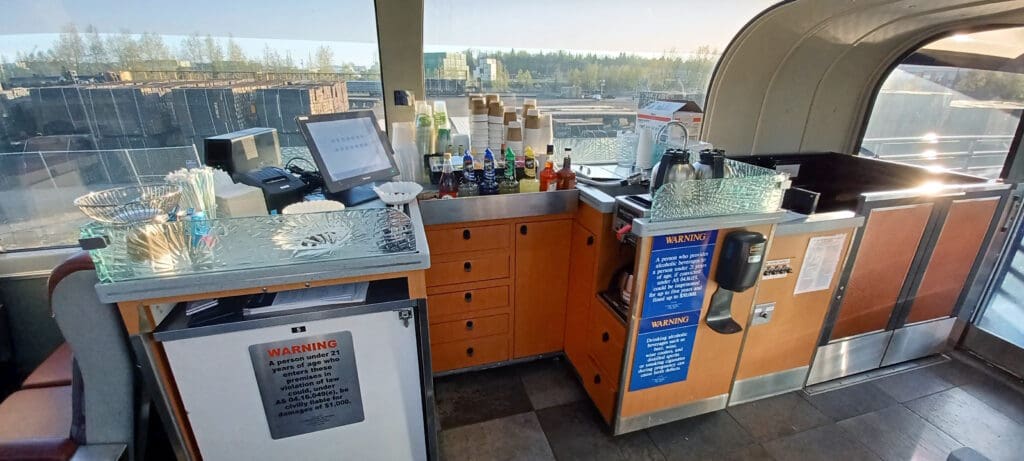 a small kitchen with a computer and a counter