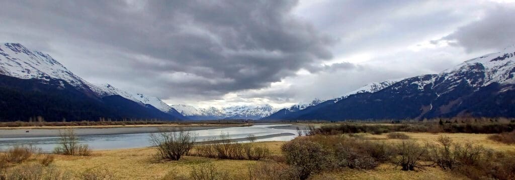 a river with mountains in the background