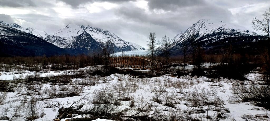 a bridge over a snowy mountain