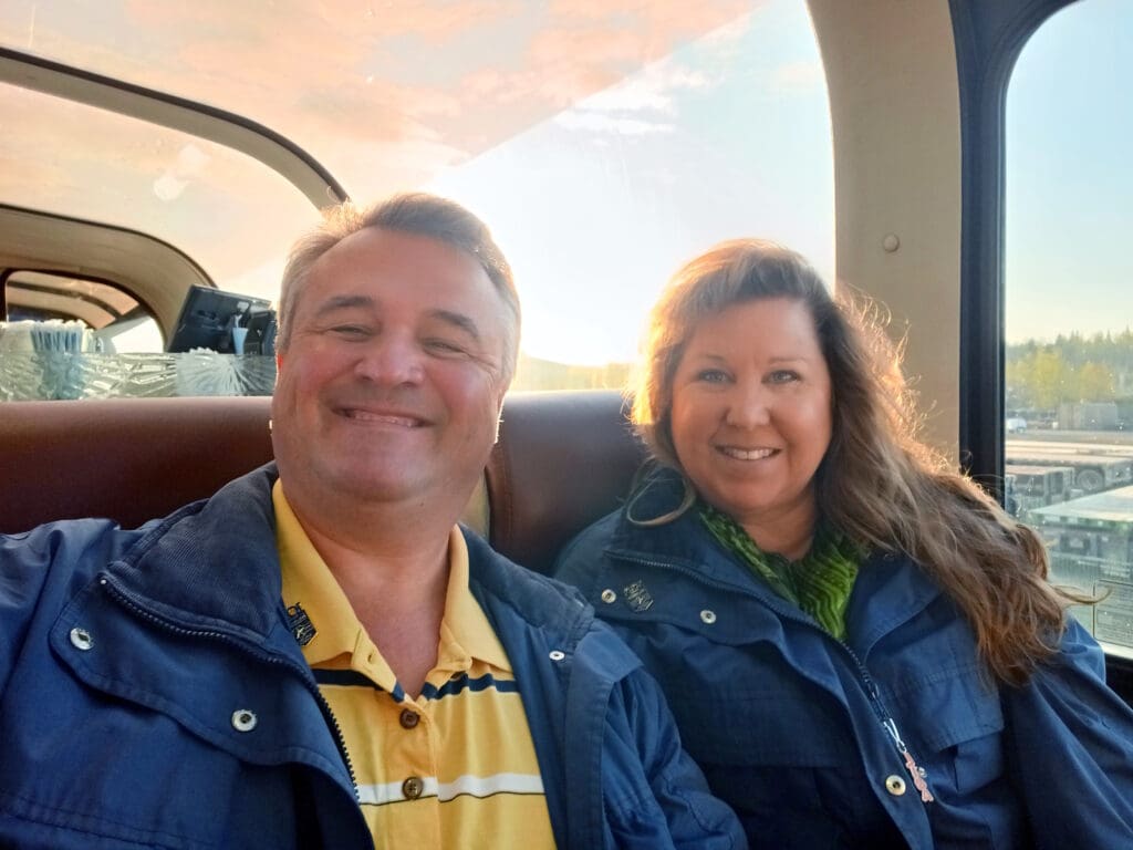 a man and woman sitting in a car