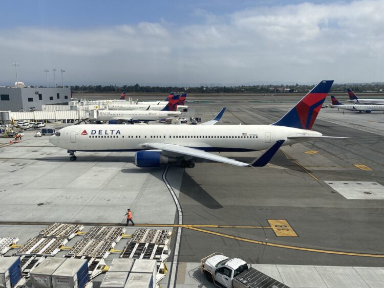 A Delta Air Lines 767-300 (tail number N174DZ) arrives at a Terminal 3 gate at Los Angeles International Airport (LAX) in California.