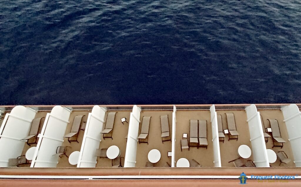 a deck of a cruise ship with chairs and tables